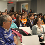 Minister Vandal, Lisa Koperqualuk, and other audience members sitting at the event