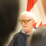 Inuit Elder Piita Irniq bringing greetings at a podium
