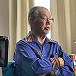 Maxime Morin, wearing a blue shirt with a woven Métis collar.